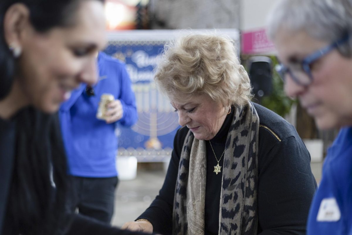 Rebecca Mace-Reeve looks at jewelry during the Jewish Federation of the Bluegrass's 3rd annual Hanukkah Market on Sunday, Dec. 7, 2025, at Greyline Station in Lexington Ky. Photo by Gavin Breunig | Staff