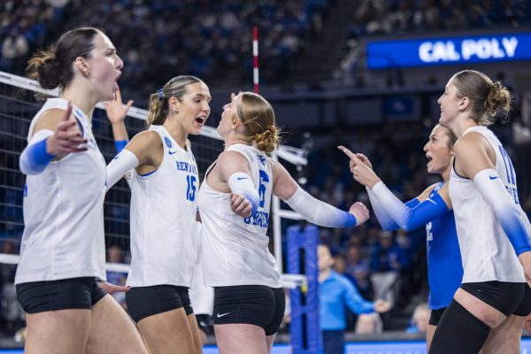 Kentucky Wildcats middle blocker Lizzie Carr cheers with Kentucky Wildcats setter Kassie O'Brien after scoring a point during the NCAA Sweet 16 volleyball match against Cal Poly on Thursday, Dec. 11, 2025, at Historic Memorial Coliseum in Lexington, Ky. Photo by Christian Kantosky | Photo Editor
