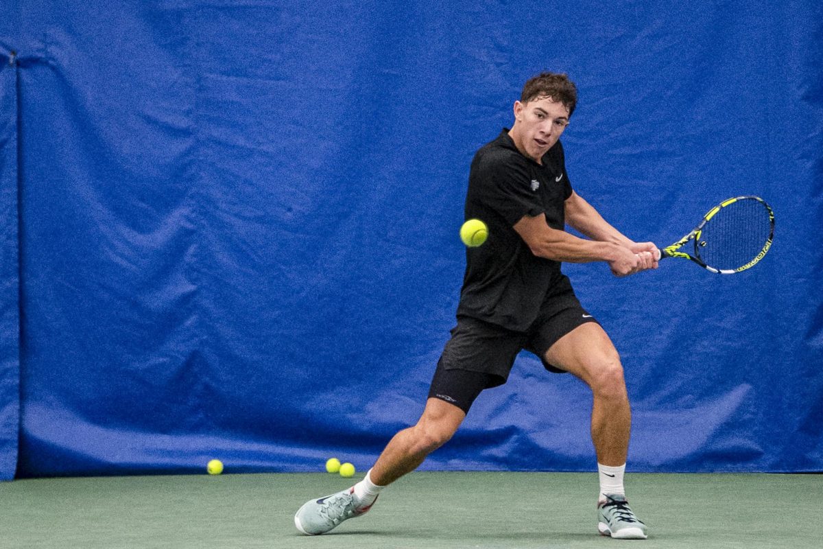 Mikael Arseneault, a freshman tennis player, swings to hit an incoming ball on Thursday, Nov. 20, 2025 at the Hilary J. Boone Tennis Center in Lexington, Ky. Photo by Olivia White | Staff