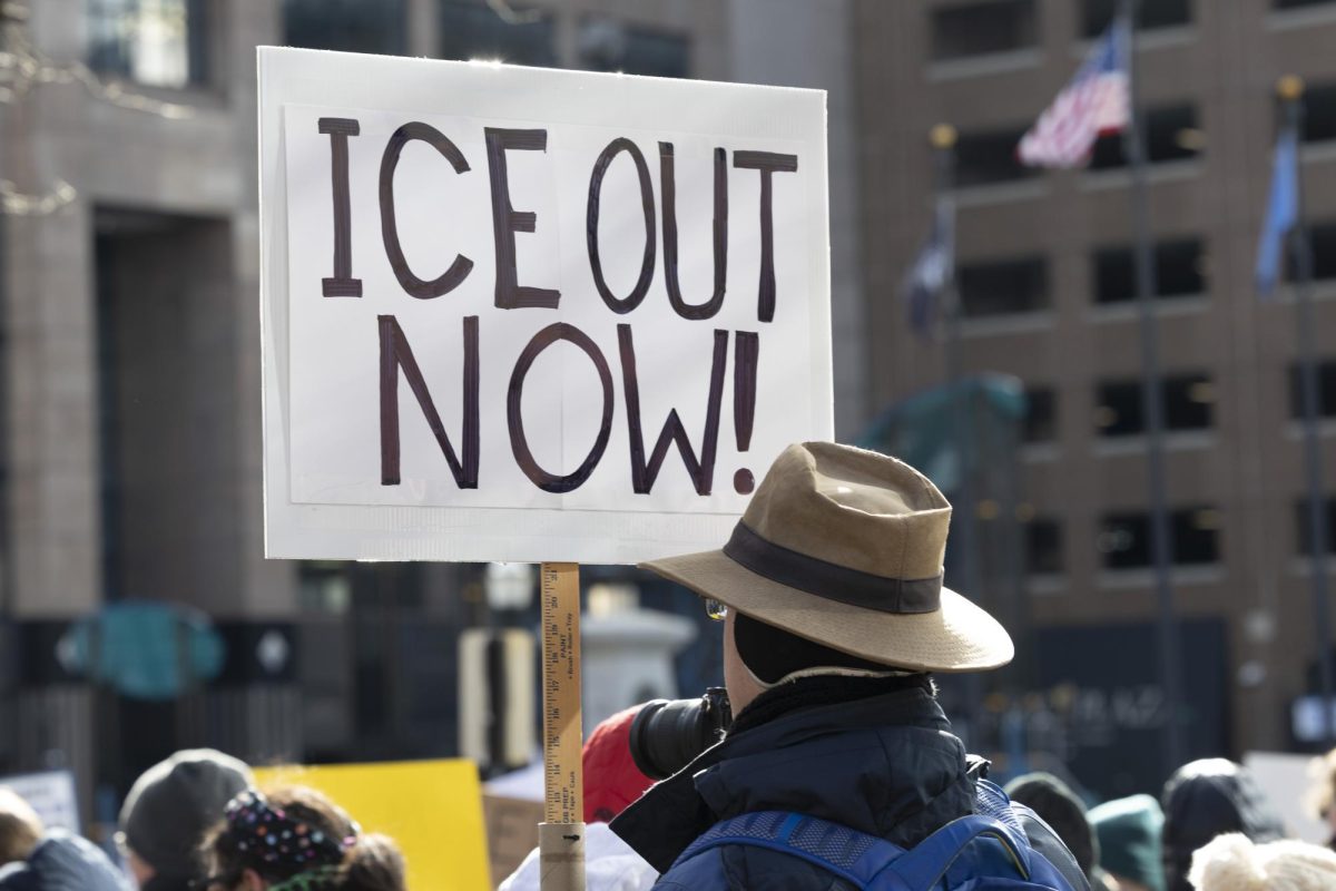 A protester holds a sign during the Anti ICE Protest at the Robert F. Stephens Courthouse Plaza in Lexington, Ky.  Photo by Kate Bonafede | Staff