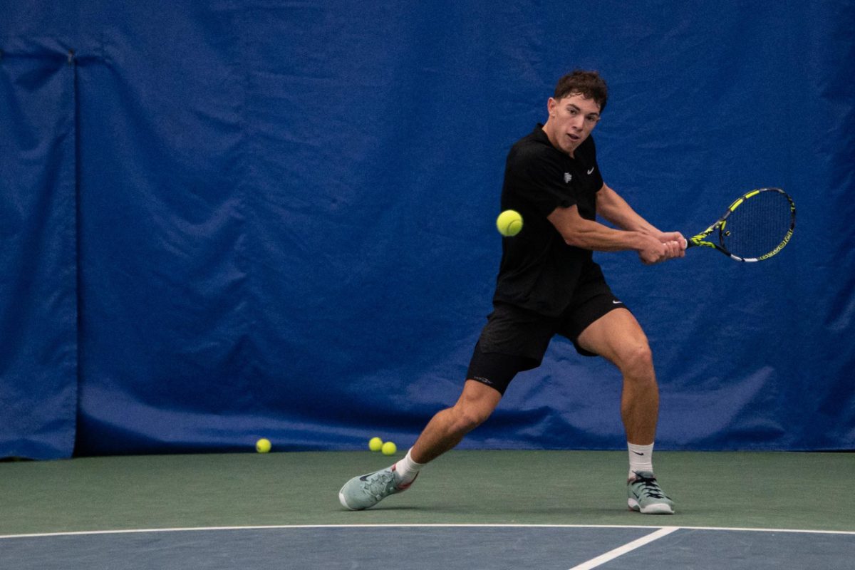 Mikael Arseneault, a freshman tennis player, swings to hit an incoming ball on Thursday, Nov. 20, 2025 at the Hilary J. Boone Tennis Center in Lexington, Ky. Photo by Olivia White | Kentucky Kernel