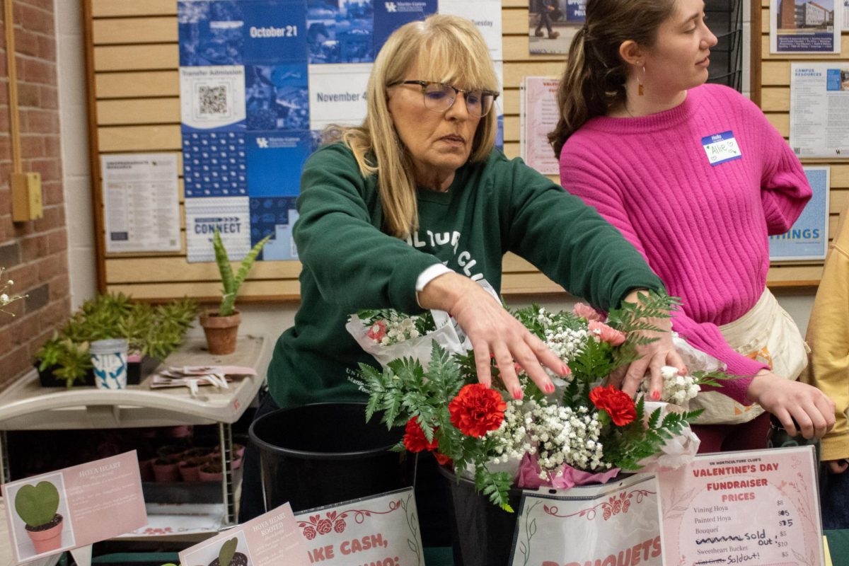 Leslie Foy, a Donovan Scholar, rearranges the flowers at the Horticulture Club Valentine's Day Fundraiser at the Agricultural Science Center North on Friday, Feb. 13, 2026, in Lexington, Ky. Photo by Brooke Johnson | Kentucky Kernel
