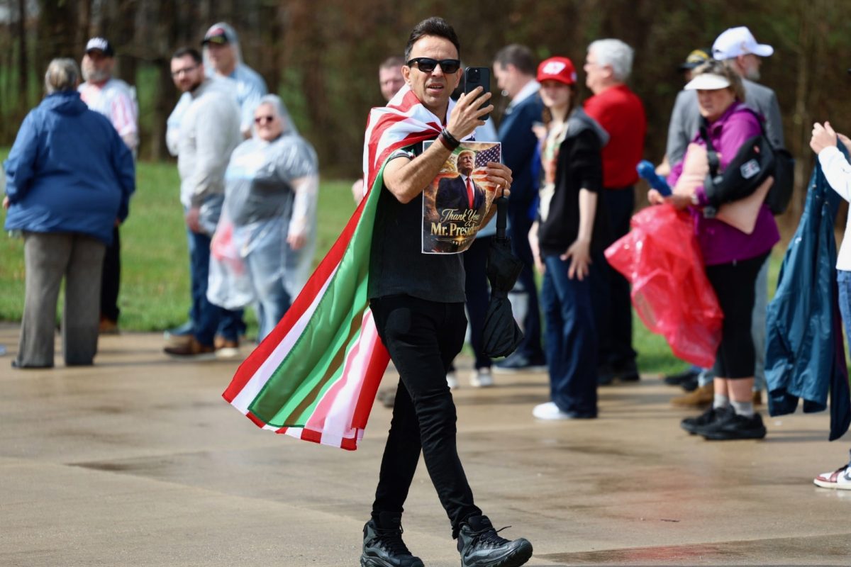 Mehdi Meftahi records the line forming outside Verst Logistics before President Donald J. Trump’s remarks on Wednesday, March 11, 2026, in Hebron, Ky. Photo by Brooke Johnson | Kentucky Kernel