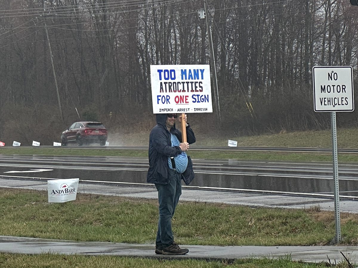 Protester stands outside Verst Logistics during President Donald J. Trump’s remarks on Wednesday, March 11, 2026, in Hebron, Ky. Photo by Brooke Johnson | Kentucky Kernel