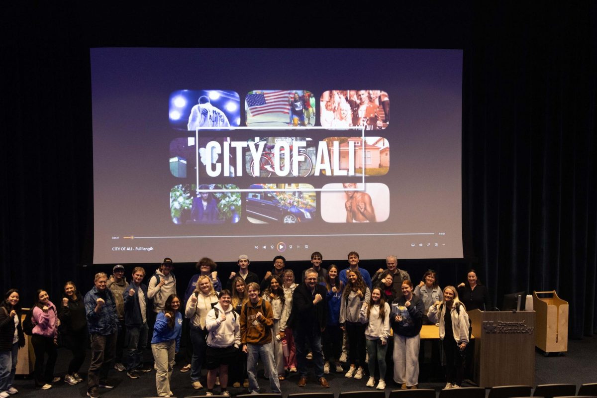 Students raise their fists for a photo during a screening of “City of Ali,” on Wednesday, Feb. 25, 2026, in the Gatton Student Center at the University of Kentucky in Lexington, Ky. Photo by Sidney Miller | Kentucky Kernel