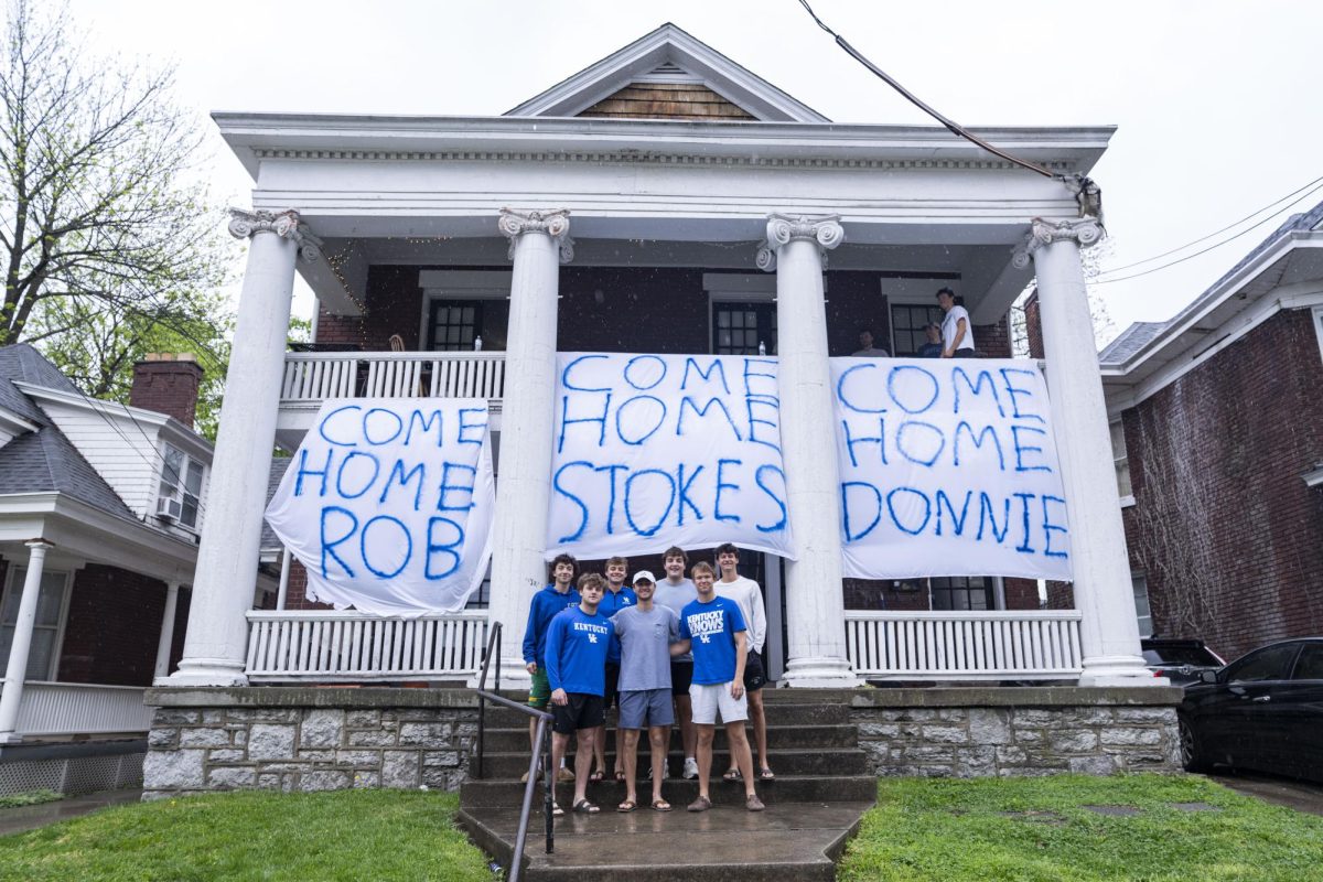 Members of Sigma Chi fraternity pose on Monday, April 13, 2026, at the Sigma Chi fraternity house in Lexington, Ky. Sigma Chi spray painted banners for recruits on official visits. Photo by Will Luckett | Kentucky Kernel
