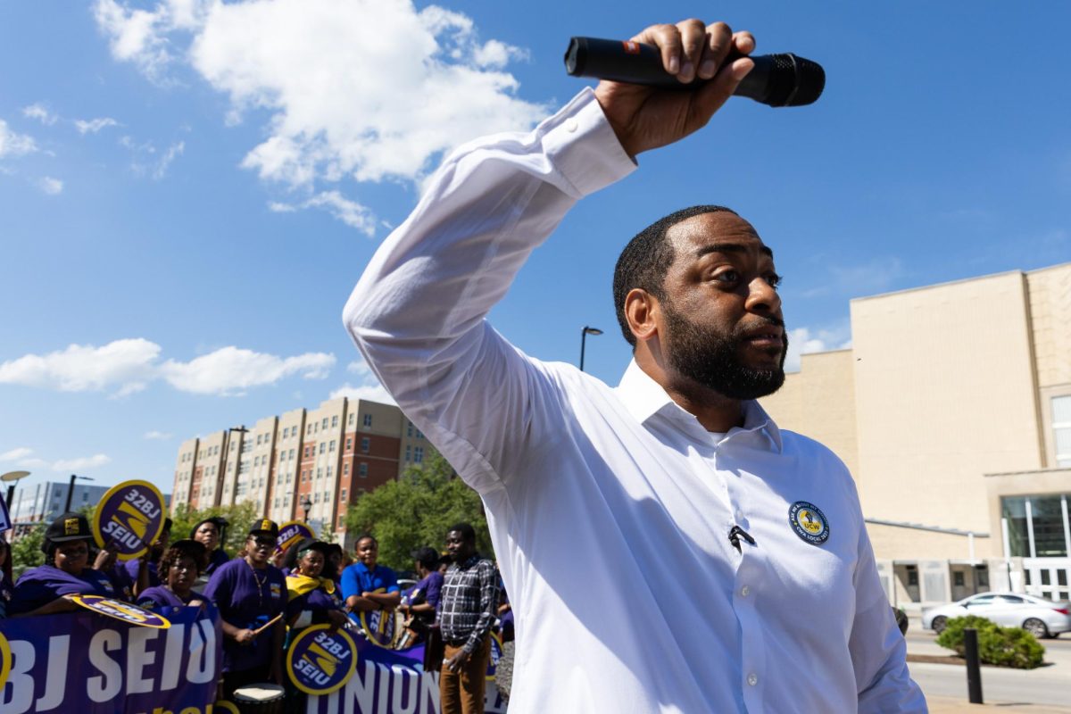 Charles Booker points the mic towards the crowd during the protest organized by United Campus Workers and 32BJ SEIU on Monday, May 4, 2026, at the University of Kentucky in Lexington, Ky. Photo by Scout Tarquinio | Kentucky Kernel