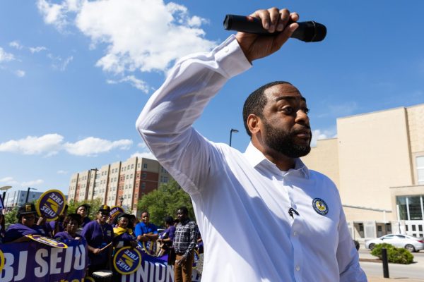 Charles Booker points the mic towards the crowd during the protest organized by United Campus Workers and 32BJ SEIU on Monday, May 4, 2026, at the University of Kentucky in Lexington, Ky. Photo by Scout Tarquinio | Kentucky Kernel